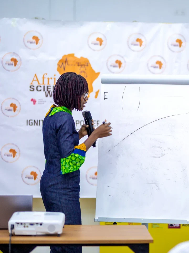 A Science Cafe speaker presenting at a flip chart